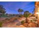 Scenic backyard with a well-manicured lawn, lush landscaping, and privacy fencing at 11342 Winter Cottage Pl, Las Vegas, NV 89135