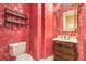 Elegant powder room featuring red toile wallpaper, marble countertop, and custom dark wood vanity at 11342 Winter Cottage Pl, Las Vegas, NV 89135