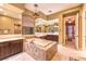 Primary bathroom featuring dual vanities, large mirrors, soaking tub, and separate shower at 11342 Winter Cottage Pl, Las Vegas, NV 89135