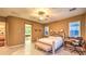 Large bedroom with tile flooring, ceiling fan, neutral walls, and desk and chair space at 11342 Winter Cottage Pl, Las Vegas, NV 89135