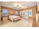 Spacious bedroom features plantation shutters, tile flooring, ceiling fan and double doors to the outside at 11342 Winter Cottage Pl, Las Vegas, NV 89135