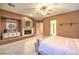 Cozy bedroom with fireplace, tile flooring, ceiling fan, and built-in cabinets at 11342 Winter Cottage Pl, Las Vegas, NV 89135