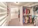 Walk-in closet with custom shelving and plenty of hanging space for clothes and accessories at 11342 Winter Cottage Pl, Las Vegas, NV 89135
