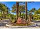 Elegant Red Rock Country Club entrance with lush landscaping and a welcoming sign at 11342 Winter Cottage Pl, Las Vegas, NV 89135