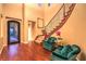 Grand foyer boasts hardwood flooring and an elegant staircase with iron spindles at 11342 Winter Cottage Pl, Las Vegas, NV 89135
