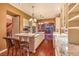 The eat-in kitchen boasts a central island, granite countertops, and wood floors at 11342 Winter Cottage Pl, Las Vegas, NV 89135