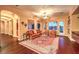The expansive living room features wood floors, neutral walls, large windows, and a ceiling fan at 11342 Winter Cottage Pl, Las Vegas, NV 89135