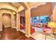 Bright living room features hardwood floors, cream-colored walls, arched doorways, and large windows at 11342 Winter Cottage Pl, Las Vegas, NV 89135