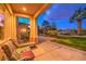 Inviting covered patio with comfortable seating and a view of the landscaped backyard at twilight at 11342 Winter Cottage Pl, Las Vegas, NV 89135