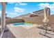 This backyard features a quaint pool with a lounge area to relax at 1206 Hopespring Loop Ave, North Las Vegas, NV 89084