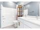 Well-lit bathroom featuring dual sinks, white cabinets, and a shower-tub combination with stylish accents at 12125 Arrebol Ave, Las Vegas, NV 89138