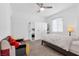 Well-lit bedroom featuring soft carpet, a ceiling fan, and built-in white wardrobes, offering ample storage and a comfortable atmosphere at 12125 Arrebol Ave, Las Vegas, NV 89138