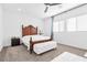 Well-lit bedroom with a vanity table and a tufted bench at 12125 Arrebol Ave, Las Vegas, NV 89138