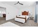 Well-lit bedroom with a vanity table and a tufted bench at 12125 Arrebol Ave, Las Vegas, NV 89138