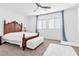 Bright bedroom with a tufted bench and large window at 12125 Arrebol Ave, Las Vegas, NV 89138