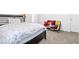Comfortable bedroom with a dark wood frame bed, soft carpet, and plenty of natural light at 12125 Arrebol Ave, Las Vegas, NV 89138
