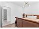 Charming bedroom featuring a wood sleigh bed with decorative wall paper in the adjoining bathroom at 12125 Arrebol Ave, Las Vegas, NV 89138
