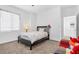 Inviting bedroom with neutral tones, a flower patterned bed, and natural light from a large window at 12125 Arrebol Ave, Las Vegas, NV 89138