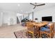 Bright dining area with a table, modern lighting, and views of the staircase at 12125 Arrebol Ave, Las Vegas, NV 89138