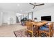 Open concept dining area with tile floors, a dining table, and views of the staircase at 12125 Arrebol Ave, Las Vegas, NV 89138