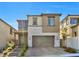 Two-story home with stone accents, a two-car garage, and a well-maintained front yard with paved driveway at 12125 Arrebol Ave, Las Vegas, NV 89138