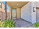 Inviting front entrance with a stone accent wall, a charming green door, and manicured landscaping at 12125 Arrebol Ave, Las Vegas, NV 89138