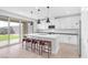Modern kitchen with stainless steel appliances, an island with seating, and bright natural light at 12125 Arrebol Ave, Las Vegas, NV 89138
