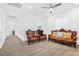 Sitting room with decorative brown leather furniture, neutral walls, and carpet at 12125 Arrebol Ave, Las Vegas, NV 89138