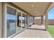 The covered patio includes a brick tile floor, columns, outdoor ceiling lights, and artificial grass in the backyard at 12125 Arrebol Ave, Las Vegas, NV 89138