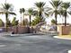 Gated community entrance features palm trees, brick walls and desert landscaping at 1463 Orange Jubilee Rd, Henderson, NV 89014