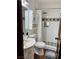 Bathroom featuring a white toilet, shower with a rainfall showerhead, sink, and tiled accents at 1780 Westwind Rd, Las Vegas, NV 89146
