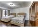 Bedroom with two beds with cushioned headboards and hardwood floors at 1780 Westwind Rd, Las Vegas, NV 89146
