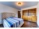 Bedroom featuring a wooden built-in storage cabinet, wood floors, and a plush bed at 1780 Westwind Rd, Las Vegas, NV 89146