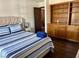 Comfortable bedroom with a built-in wooden cabinet, wood floors, and a plush bed at 1780 Westwind Rd, Las Vegas, NV 89146