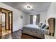 Bedroom with dark wood floors, a tufted headboard, and a connecting bathroom at 1780 Westwind Rd, Las Vegas, NV 89146