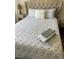 Bedroom with decorative floral bedding and light-colored floors at 1780 Westwind Rd, Las Vegas, NV 89146