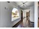 Bright hallway featuring dark wood floors, arched windows, and exterior views at 1780 Westwind Rd, Las Vegas, NV 89146