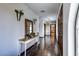 Charming entryway with a wooden console table, flower decor, and dark hardwood floors at 1780 Westwind Rd, Las Vegas, NV 89146