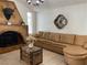 Inviting living room featuring a large sofa, fireplace, and unique lighting fixture at 1780 Westwind Rd, Las Vegas, NV 89146