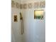 Close-up of the tiled shower with a golden shower head and built-in niche at 1780 Westwind Rd, Las Vegas, NV 89146