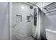 Modern shower featuring marble-look tile, stylish shower head, and built-in shelving at 1780 Westwind Rd, Las Vegas, NV 89146