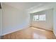 Sunlit bedroom with hardwood floors, neutral paint, and a slider to the balcony offer an outdoor connection at 1810 N Decatur Blvd # 201, Las Vegas, NV 89108