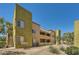 Multi-level condominium building showing well maintained landscaping and exterior stairways at 1810 N Decatur Blvd # 201, Las Vegas, NV 89108