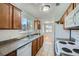 Efficient kitchen with granite countertops, wood cabinets, white appliances, and a bright, windowed breakfast nook at 1810 N Decatur Blvd # 201, Las Vegas, NV 89108