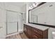 Bathroom featuring wood-look flooring, granite countertop, and a shower with glass doors at 1830 N Buffalo Dr # 2106, Las Vegas, NV 89128