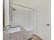 Bathroom featuring granite countertops, shower with white tile, and wood-look flooring at 1830 N Buffalo Dr # 2106, Las Vegas, NV 89128