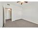 Bedroom featuring carpet, a ceiling fan, a closet, and an open doorway at 1830 N Buffalo Dr # 2106, Las Vegas, NV 89128