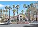 Community clubhouse with tile roof, arched entryway, landscaping, and adjacent parking at 1830 N Buffalo Dr # 2106, Las Vegas, NV 89128