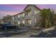Attractive two-story apartment building with balconies, stairs, landscaping, and dedicated parking at 1830 N Buffalo Dr # 2106, Las Vegas, NV 89128