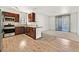 Bright kitchen featuring wood floors, stainless steel appliances, granite countertops, and breakfast bar at 1830 N Buffalo Dr # 2106, Las Vegas, NV 89128